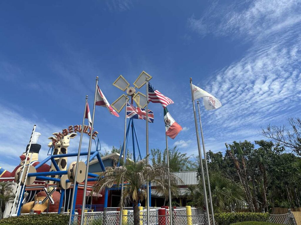 Amberville play area and international flags at Give Kids The World Village in Kissimmee.