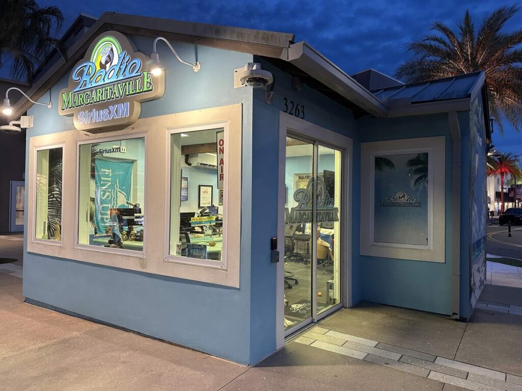 Exterior of the Radio Margaritaville SiriusXM studio lit up at night.