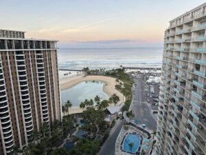 Early morning view of Waikīkī, the Pacific Ocean, and surrounding hotel towers from above.