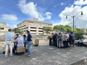 Elderly men gathered outdoors playing games in Honolulu’s Chinatown.