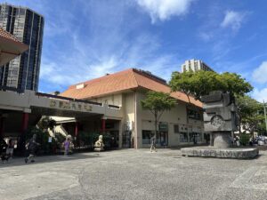 Chinatown Cultural Plaza area in Honolulu with buildings and a public monument.