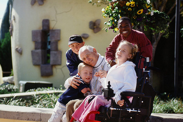 Give Kids The World founder Henri Landwirth smiling with wish children at Give Kids The World Village in Kissimmee, Florida.