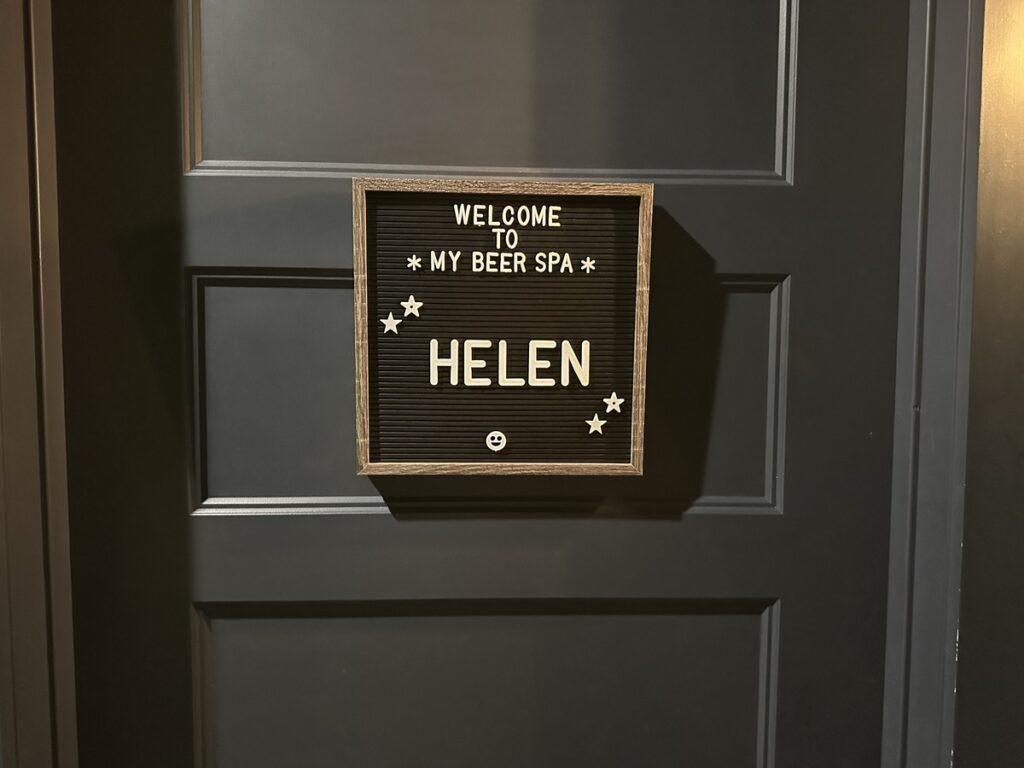 Personalized sign on a private spa room door reading “Welcome to My Beer Spa Helen.”
