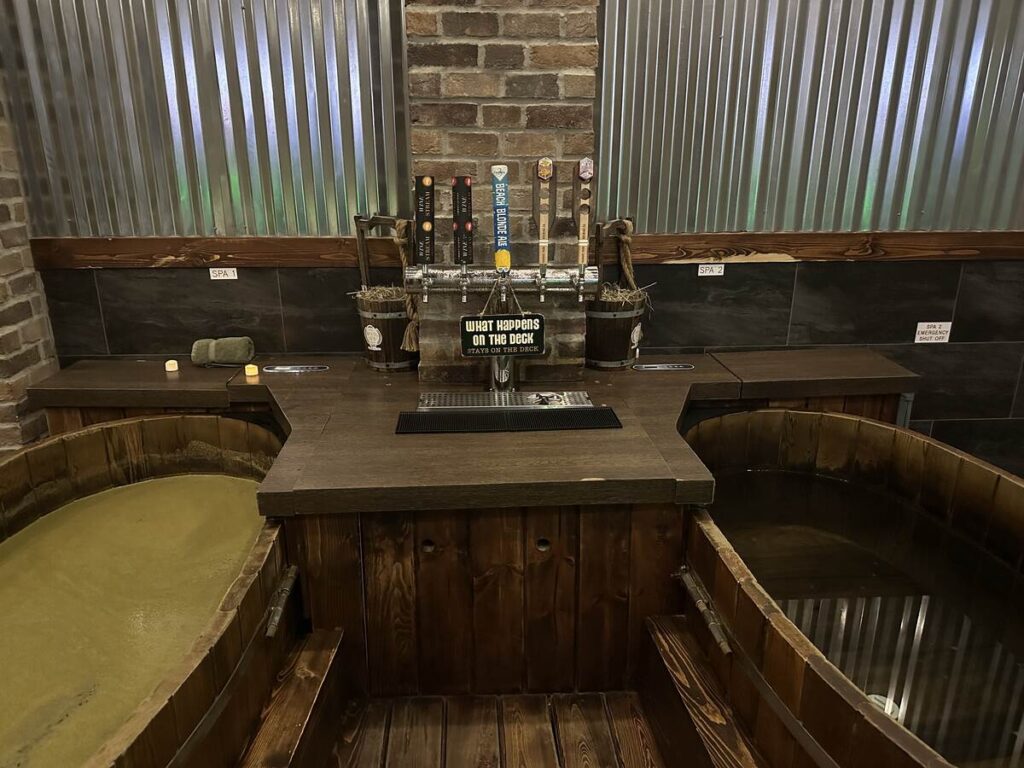 Private My Beer Spa suite with two deep wooden soaking tubs and beverage taps between them.