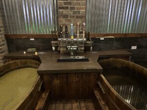Private My Beer Spa suite with two deep wooden soaking tubs and beverage taps between them.