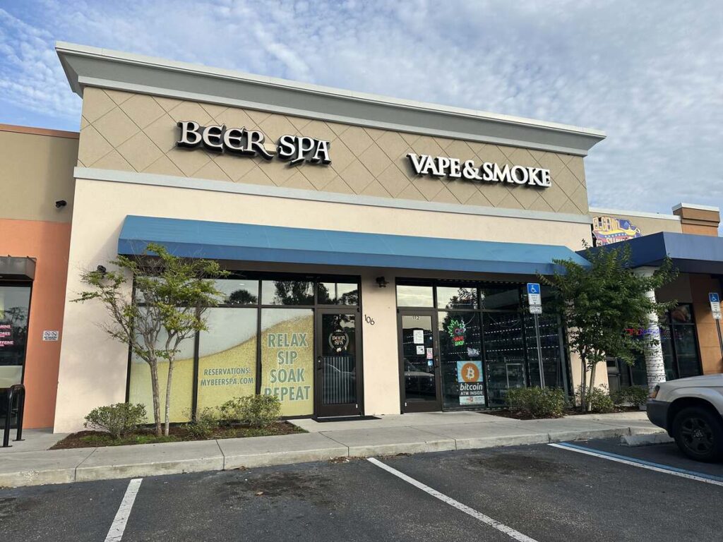 Exterior storefront of My Beer Spa on International Drive in Orlando, with blue awning and “Beer Spa” sign.