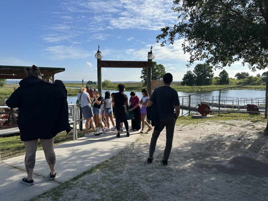 Visitors gathering near the airboat dock at Boggy Creek before boarding.