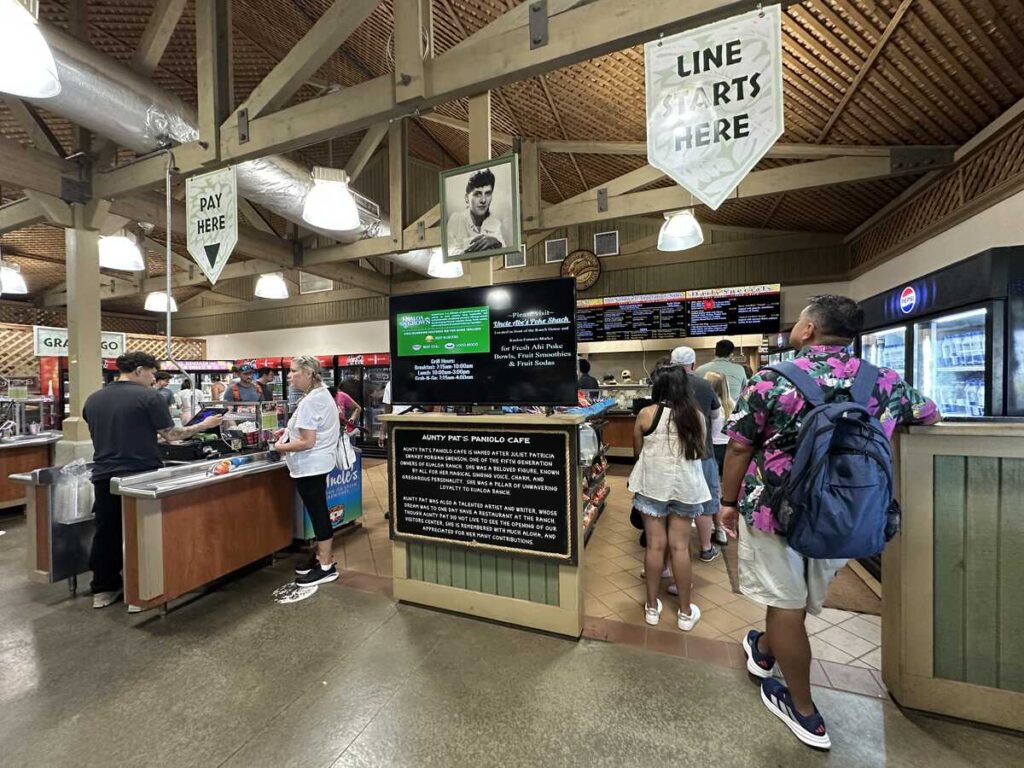 Visitors line up for food at Aunty Pat’s Paniolo Café inside Kualoa Ranch.