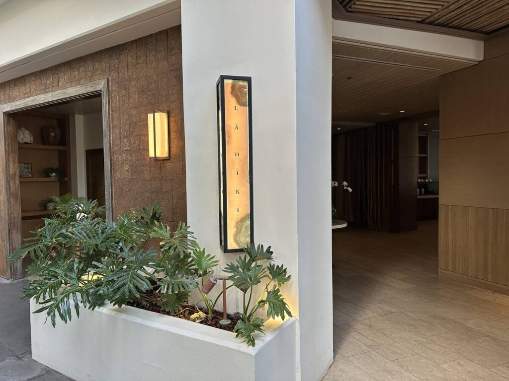 Entrance to La Hiki restaurant at Four Seasons Resort Oahu with tropical plants and warm lighting.