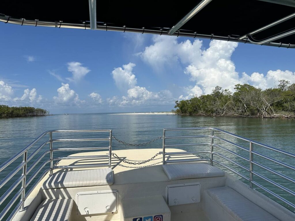 View from the bow of a tour boat toward a quiet barrier island beach near Marco Island and the Ten Thousand Islands.