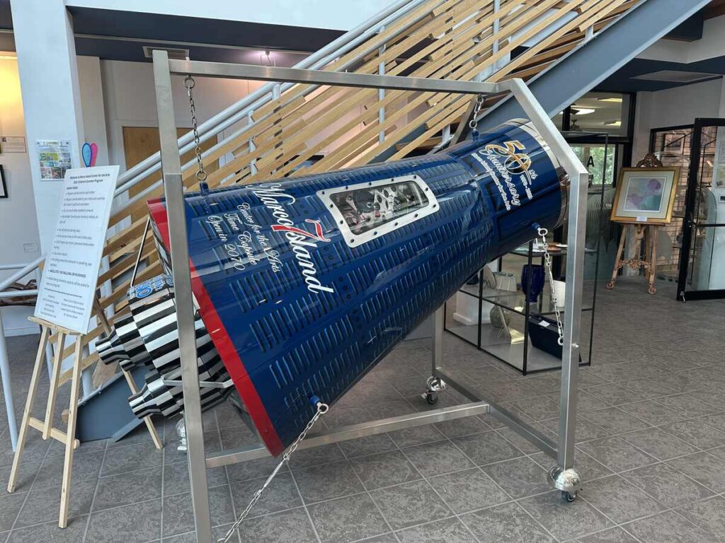 Spaceship-themed stainless steel time capsule displayed at Marco Island Center for the Arts.