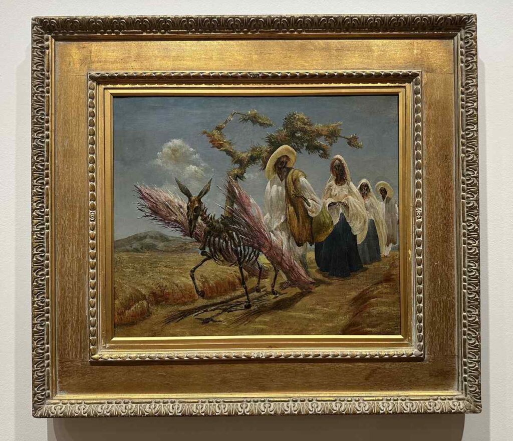 Framed Guillermo Meza painting of mule drivers walking beside a skeletal winged animal in a desert landscape.