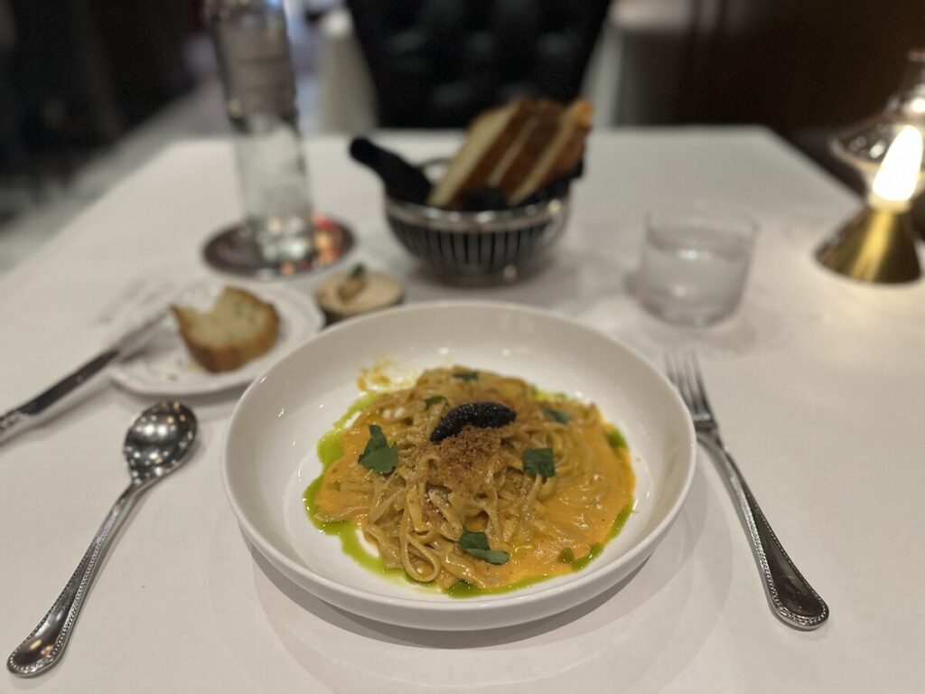 Linguine special served at Tulia Italian Steak on Fifth Avenue South in Naples, Florida, with creamy sauce, herbs, and a dark garnish.