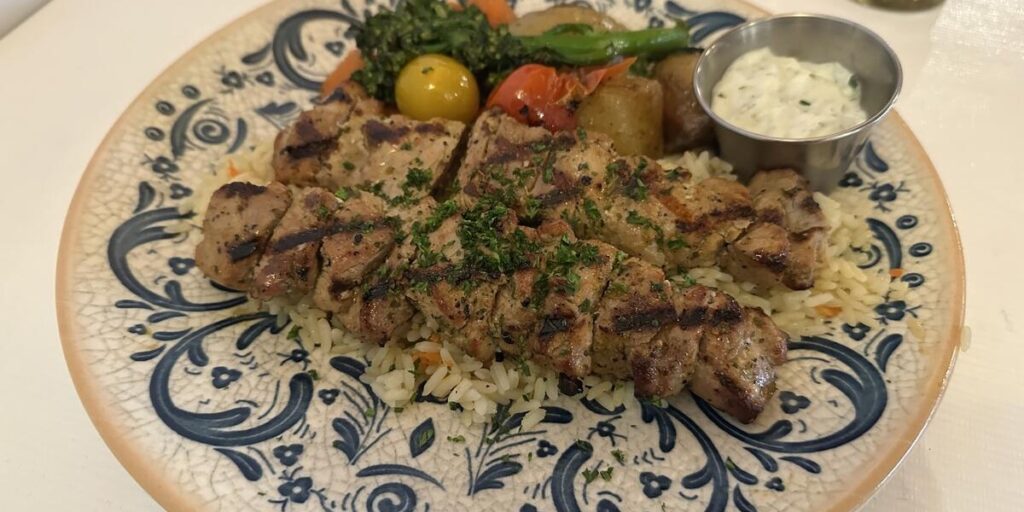 Grilled Greek meal with rice, vegetables and tzatziki at Ithaka in Victoria, BC.