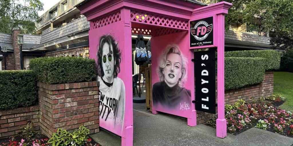 Bright pink Floyd’s Diner entrance with portraits of John Lennon and Marilyn Monroe in Victoria.