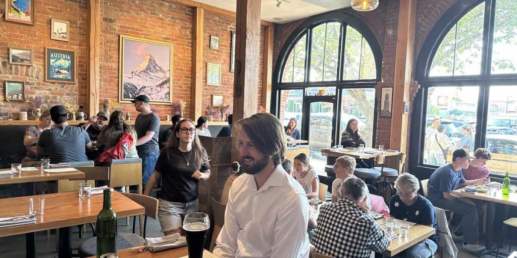 Brick-walled dining room with arched windows at Eva Schnitzelhaus in Victoria.