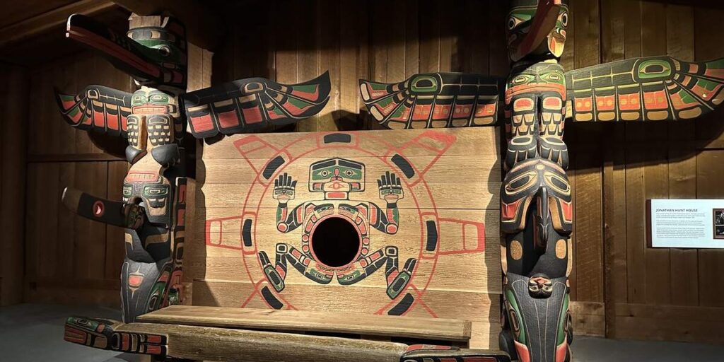 Large Indigenous carvings and painted ceremonial display at the Royal BC Museum.