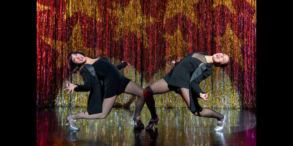 Lissa deGuzman and Reece Weaver strike matching dance poses during Chicago.