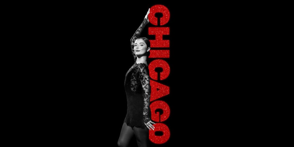 Reece Weaver poses beside the vertical red Chicago logo.